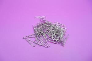 Triangle Paper Clips on Pink Background photo