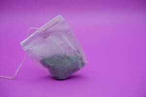 Simple Teabags with String on Pink Surface photo