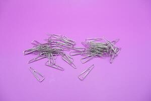 Pile of Silver Triangle Paper Clips Isolated photo