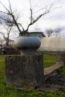The cast-iron pot stands on a concrete foundation. Soviet cast iron pot photo