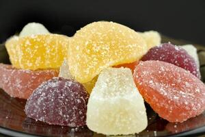 Multi-colored, marmalade candies, close-up, isolated on a black background. photo