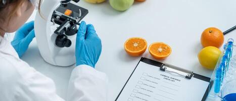Scientist check chemical food residues in laboratory. Control experts inspect quality of fruits, vegetables. lab, hazards, ROHs, find prohibited substances, contaminate. Microscope, Microbiologist photo