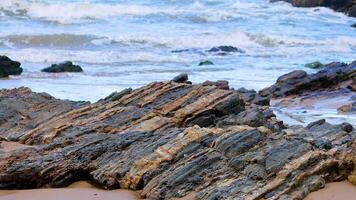 Dynamic waves crash against rugged rocks at Charlesworth Bay Beach, Coffs Harbour, under natural daylight, capturing coastal beauty video