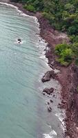 Drone footage captures the rugged coastline and lush rainforest of Port Douglas, Queensland, with dynamic ocean waves video