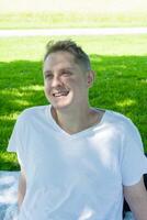 A Person With a Big Smile Enjoying a Beautiful Sunny Day in the Lovely Park Outside photo
