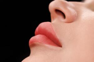 Natural pink shade with precise lip contour and smooth skin, no redness visible. photo