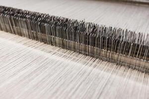 Closeup of Factory Loom Mechanism in Wool Fabric Production Industrial Textile Manufacturing Process photo