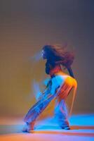 Energetic dancers in vibrant attire performing jazz-funk choreography in a modern studio, showcasing dynamic movements, expressive poses, and synchronized group formations. photo