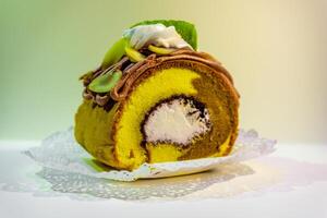 A cake with cream and green leaves on it photo