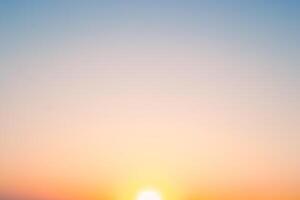 The sunset sky gradient transitions from deep orange to soft blue, capturing a moment of natural beauty photo