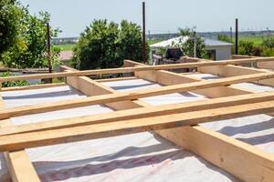 The timber roof frame of the building is under construction, structural support photo