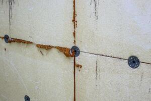 Close-up of external wall insulation with polystyrene foam with fasteners and sealant showing construction details photo