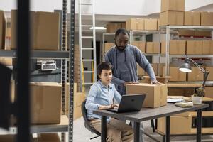 Team of employees managing distribution operations in supply room, focusing on product handling and custom order management. E commerce local brand development in industrial depot. photo