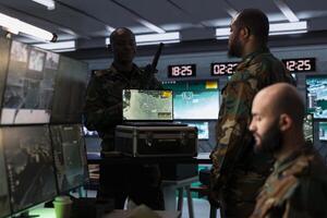 Air defense specialist using radar on laptop to detect missile attacks and conducting space surveillance and satellite tracking. Army expert using military software on notebook preventing rockets photo
