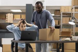 Multiethnic workers getting annoyed by order mix up before shipment, struggling to solve custom orders problem. Stressed staff working hard for express delivery, logistics mess. photo