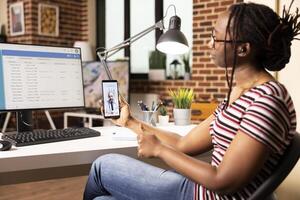 Female data analyst in virtual meeting with caucasian doctor, discussing updates to hospital digital system. Black woman consulting with physician through call during healthcare database session photo