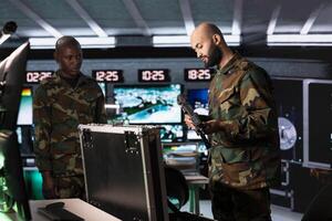 Army solders packing weapons able to engage targets at extended range with accurate, lethal fire. Military units loading guns with bullets, preparing to start mission to suppress enemy photo