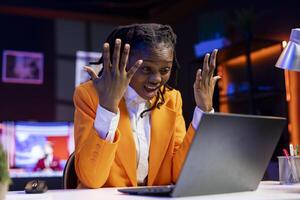 Angry freelancer at desk yelling while working from home in apartment office, upset by error on laptop screen. Stressed woman raging, having burnout while doing tasks on notebook photo