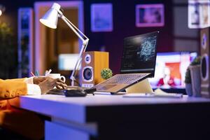 Admin using notebook in home office for artificial intelligence computing simulating human brain through self learning algorithms. Employee working with AI deep neural networks on laptop photo