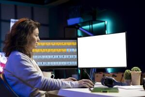 Freelancer working on isolated screen PC on digital portfolio showcasing photoshoot edited images. Photo editor selecting best photographs using retouching software interface on mockup monitor