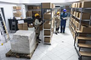 Diverse team of employees work in a storehouse for import export and distribution system, managing cargo boxes from shelves. Staff ensuring inventory process in the logistics center. photo