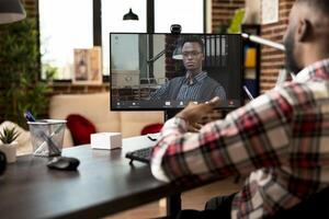 Professional african american man in conference call, working remotely from home. Virtual business collaboration between black male colleagues on company goals and marketing strategy. photo