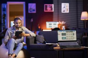 man using tablet in cozy workspace photo