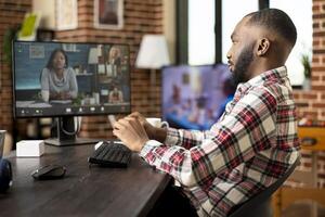Businessman remotely presenting innovative startup plan in call with diverse group of investors and partners. Entrepreneur in teleconference meeting, networking with multiethnic professionals. photo