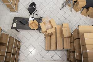 Empty supply room with logistics and shipment area of a local retail business, space used for product handling and hand packing to ensure the distribution of goods. Industrial warehouse. photo