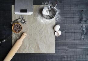 Baking Tools on Black Wood with Parchment Paper photo