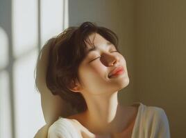 A woman is smiling and looking up at the sun photo