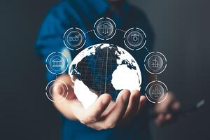 A hand holds a glowing globe surrounded by icons representing environment, energy, and care, emphasizing sustainability, renewable energy, eco-friendly practices, and a commitment to a greener future. photo