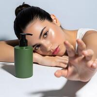 Beauty product advertisement featuring a radiant woman with a natural skincare bottle, A serene beauty portrait featuring a womans glowing skin and a minimalist green product photo