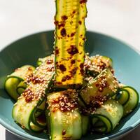 Cucumber Salad with Chili Oil and Sesame Seeds in a Teal Bowl, Light and Airy Korean Style Cucumber Salad with Spicy Gochujang photo