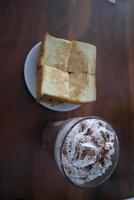 A glass of hot chocolate and a slice of toast photo