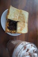 A sandwich and a drink on a table photo