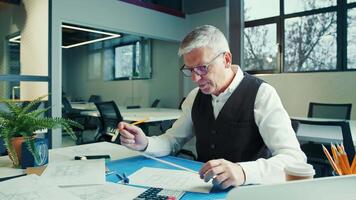 Senior Architect Engages in Creative Design Process at Modern Office Space During Afternoon video