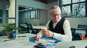 Senior Architect Discussing Design Concepts While Enjoying Coffee in Modern Office Setting video