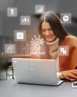 Woman engaged in online conversation with chatbot while working on laptop in a modern cafe photo