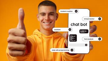 Young man shows smartphone with chatbot features against a vibrant orange background while giving a thumbs up photo