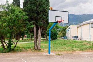 Outdoor basketball hoop in a public park. Urban recreation, sports activity, and healthy lifestyle in a community setting photo