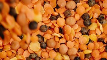 A detailed view of lentils and chickpeas rotating, highlighting texture and color in bright lighting video