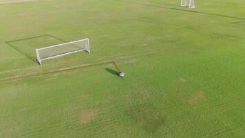 A robot autonomously paints lines on a soccer field, showcasing precision and efficiency in an outdoor setting video