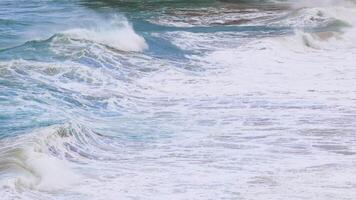 Dynamic ocean waves crash against the shore at Port Campbell, captured in natural light with a steady camera video