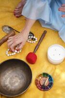 Calm hand arranges spiritual objects for meditation practice. Image is useful for illustrating mindfulness, wellness, or holistic lifestyle concepts. photo
