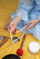 Calm person holds prayer beads. This image is used for meditation, mindfulness, or spiritual practice context. photo
