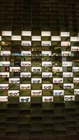 Organized eyewear display. Retail store image for commercial, marketing, or product catalog use, showing various eyeglasses on illuminated shelves. photo