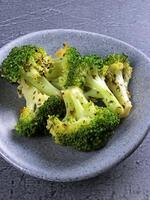 Steamed broccoli in a gray bowl photo