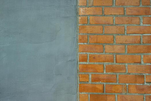 Horizontal abstract background of smooth grey cement wall next to red brick block pattern, equally divided. Rustic industrial style for creative design or text space. photo