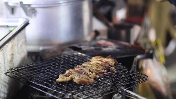 Sequential grilling and serving of meat at a stall video